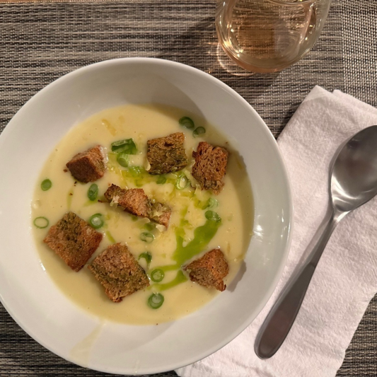 bowl of creamy soup topped with croutons and chives